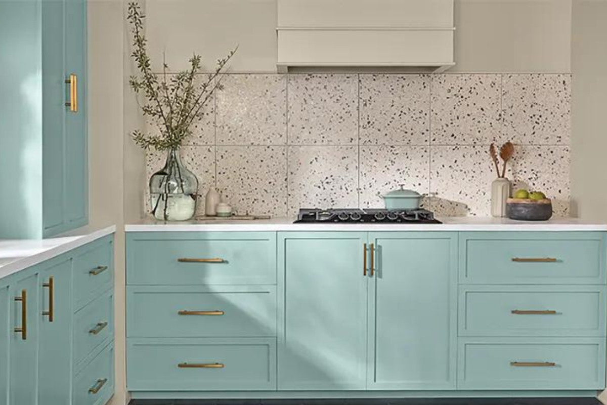 Light aqua blue kitchen cabinet design with a white terrazzo backsplash and white kitchen hood Light aqua blue kitchen cabinet design with a white terrazzo backsplash and white kitchen hood