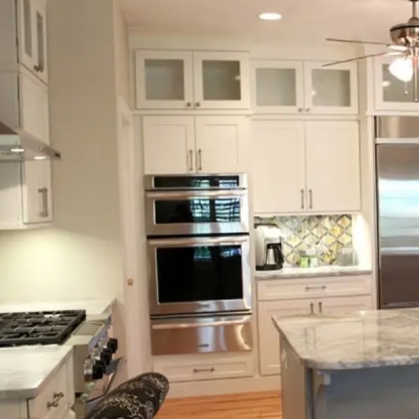White shaker kitchen with stacked glass cabinets White shaker kitchen with stacked glass cabinets and wall oven with warming drawer