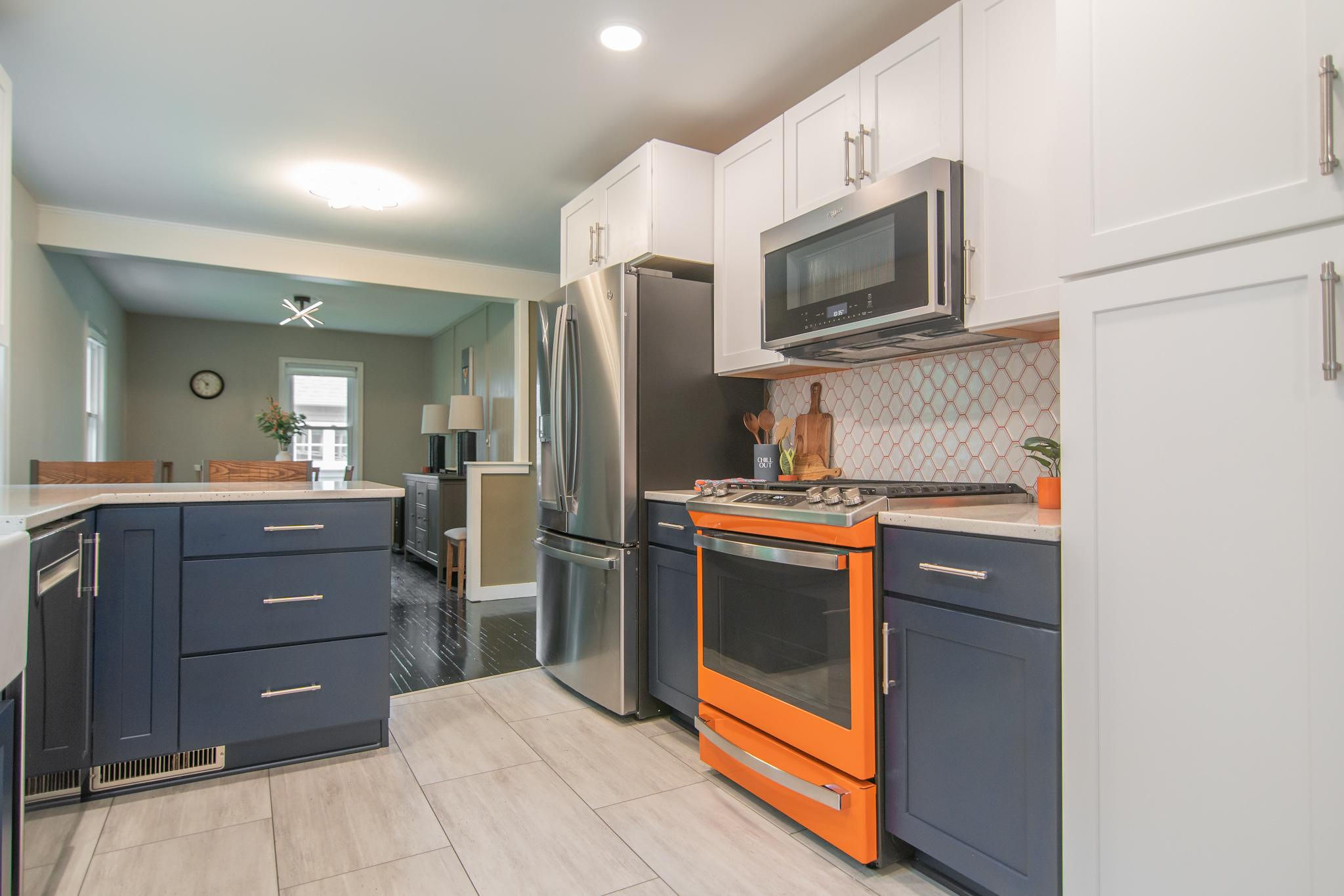 CliqStudios project: White and blue shaker kitchen cabinets with bright orange range and backsplash grout CliqStudios project: White and blue shaker kitchen cabinets with bright orange range and backsplash grout