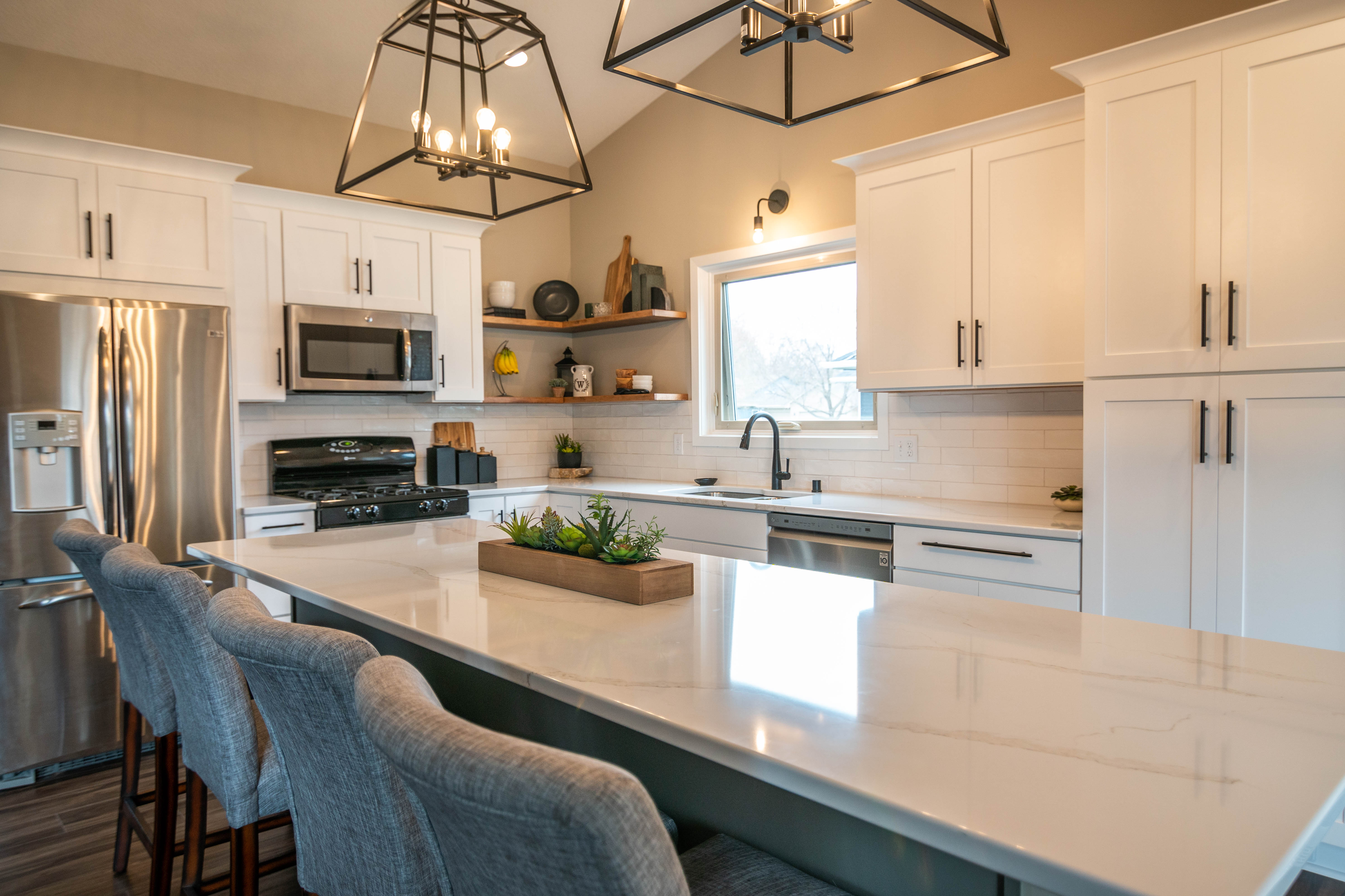 CliqStudios project: White shaker kitchen cabinets with a gray island, white quartz countertops and bronze accents CliqStudios project: White shaker kitchen cabinets with a gray island, white quartz countertops and bronze accents
