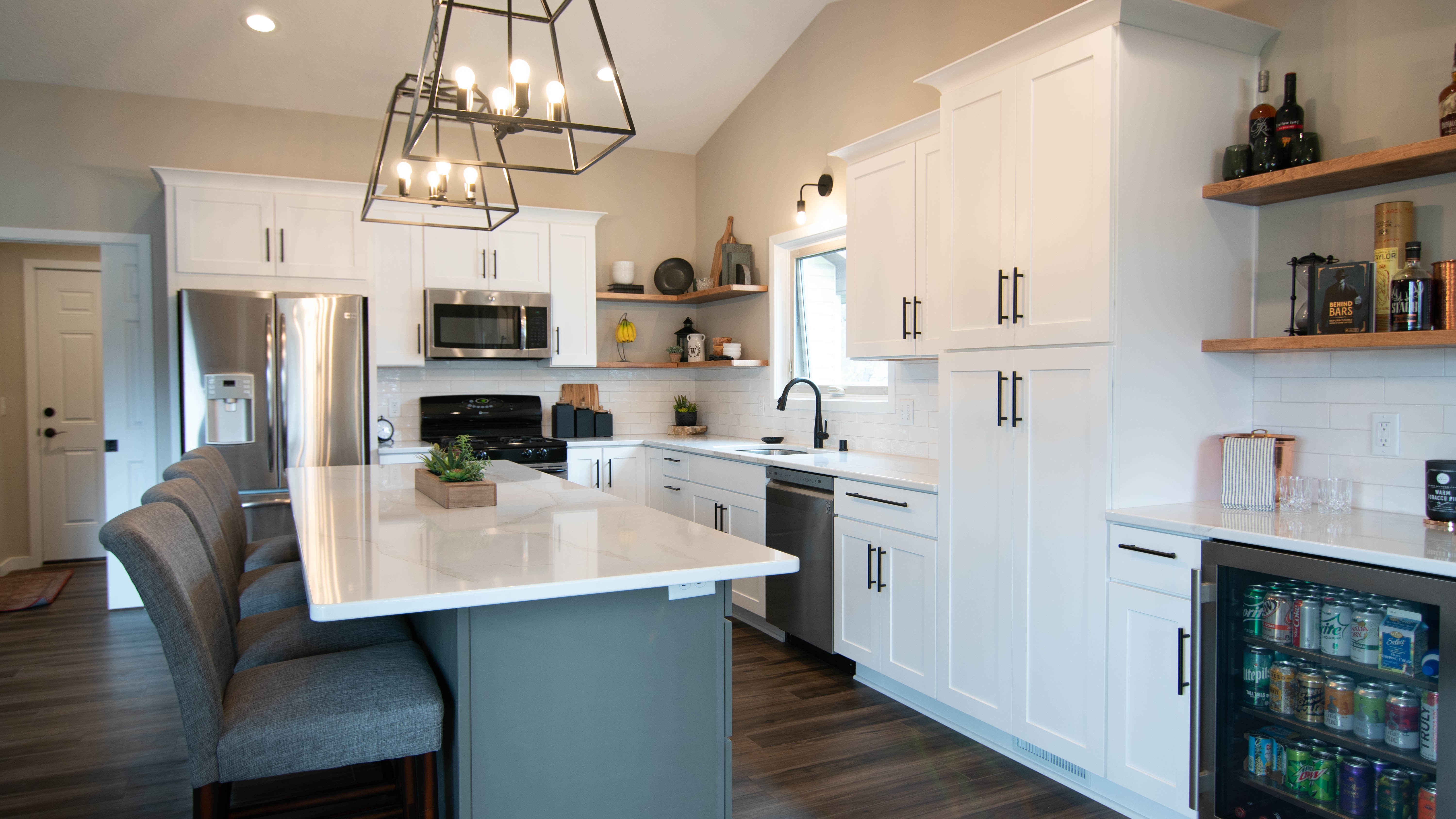 CliqStudios project: White shaker kitchen cabinets with a gray island, white quartz countertops and bronze accents CliqStudios project: White shaker kitchen cabinets with a gray island, white quartz countertops and bronze accents