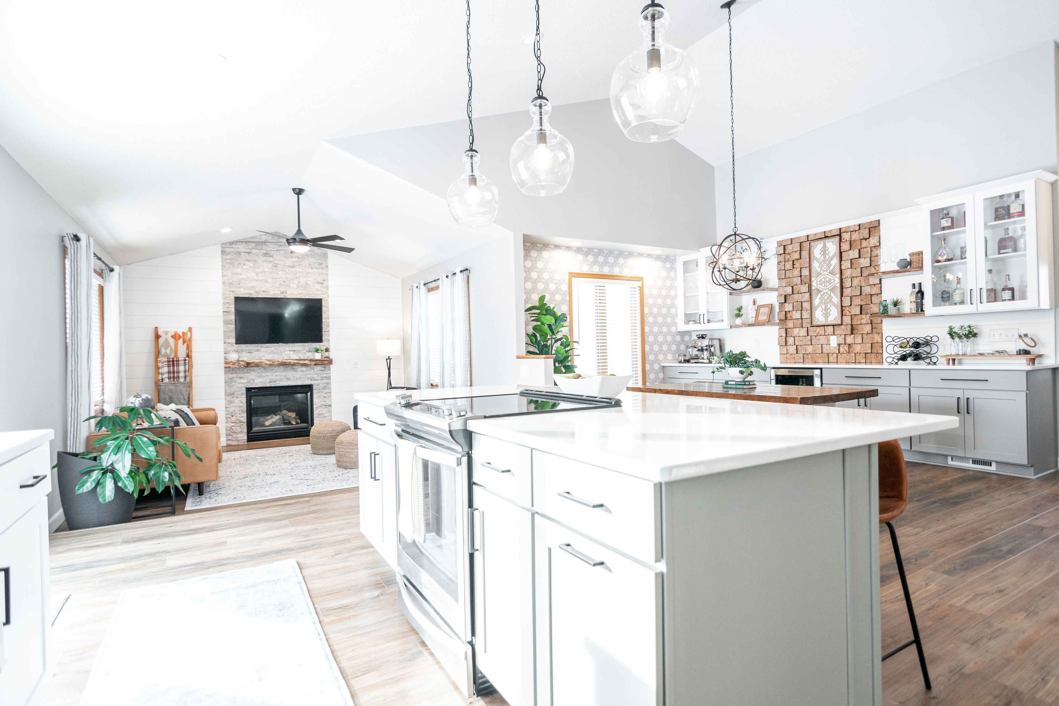 CliqStudios project: White and light gray shaker kitchen cabinets with dark cabinet hardware, light wood accents, and modern decor CliqStudios project: White and light gray shaker kitchen cabinets with dark cabinet hardware, light wood accents, and modern decor