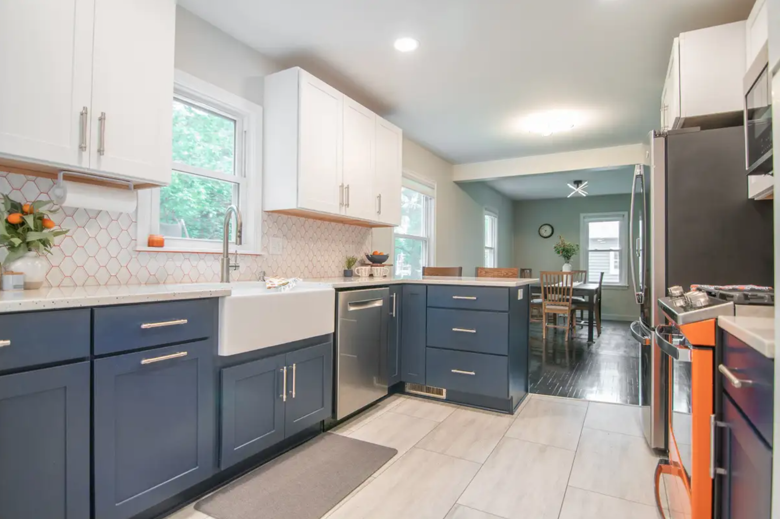 White and Navy Blue shaker kitchen cabinets with a bright orange range White and Navy Blue shaker kitchen cabinets with a bright orange range