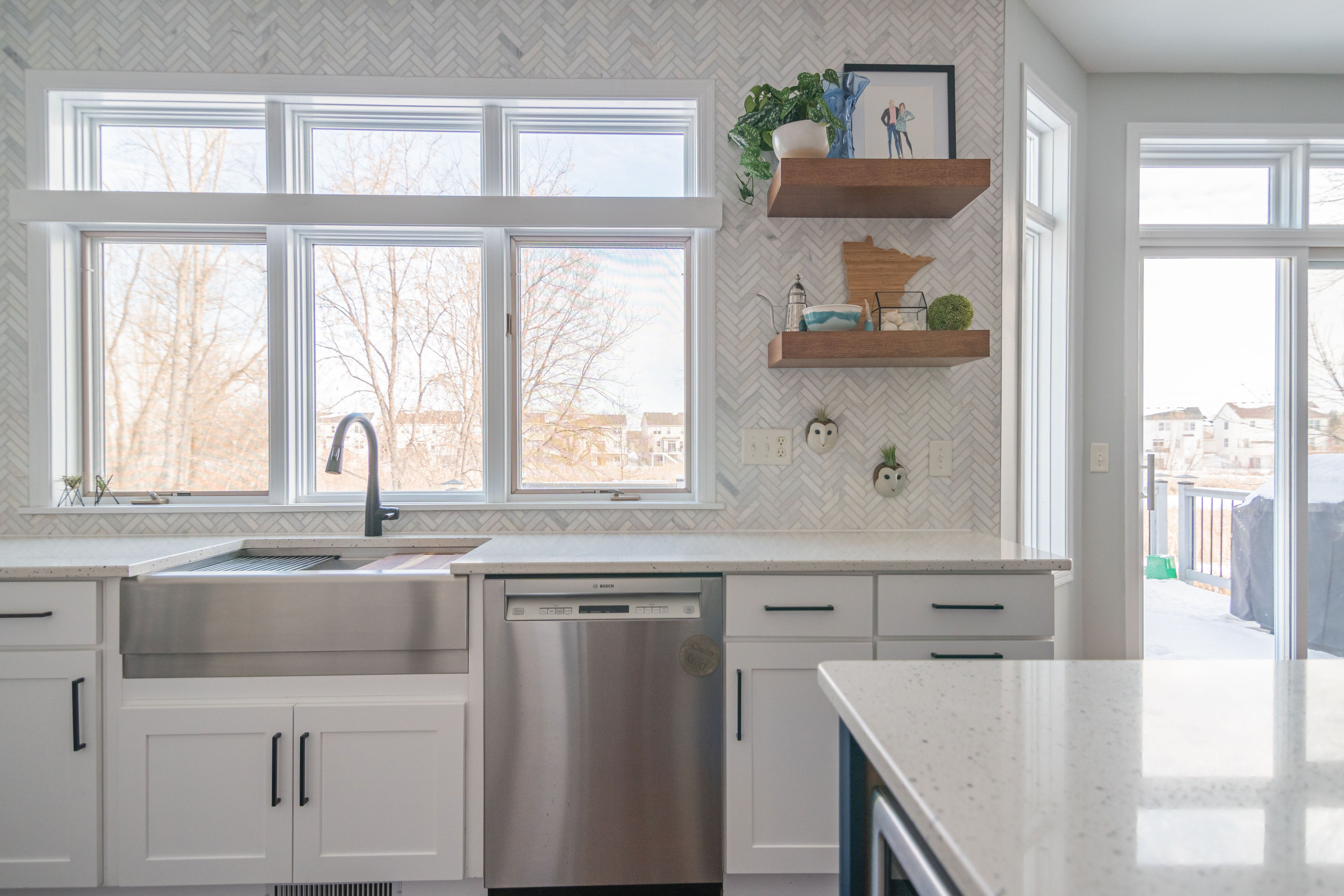 CliqStudios project: White shaker kitchen cabinets and wood floating shelves on marble herringbone tile CliqStudios project: White shaker kitchen cabinets and wood floating shelves on marble herringbone tile