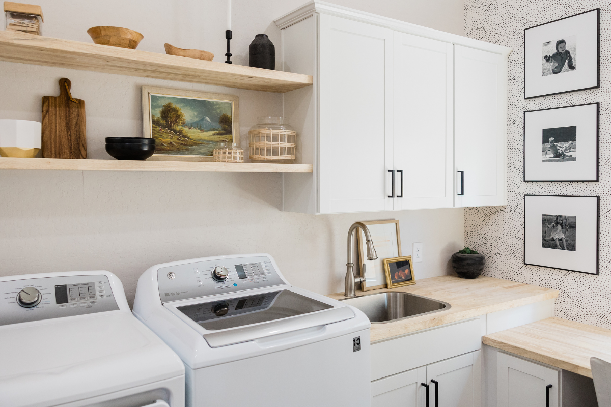 White shaker laundry room cabinets with a blonde wood butcherblock countertop White shaker laundry room cabinets with a blonde wood butcherblock countertop