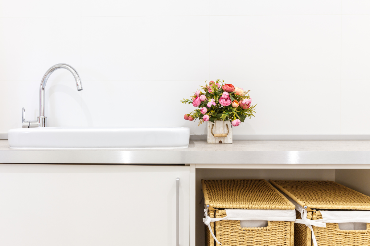 White slab laundry room cabinets with open shelving for laundry basket storage White slab laundry room cabinets with open shelving for laundry basket storage