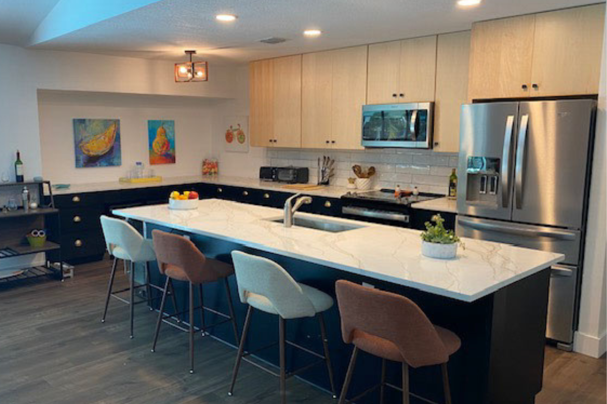 Contemporary slab kitchen design with black base cabinets and natural maple wall cabinets Contemporary slab kitchen design with black base cabinets and natural maple wall cabinets