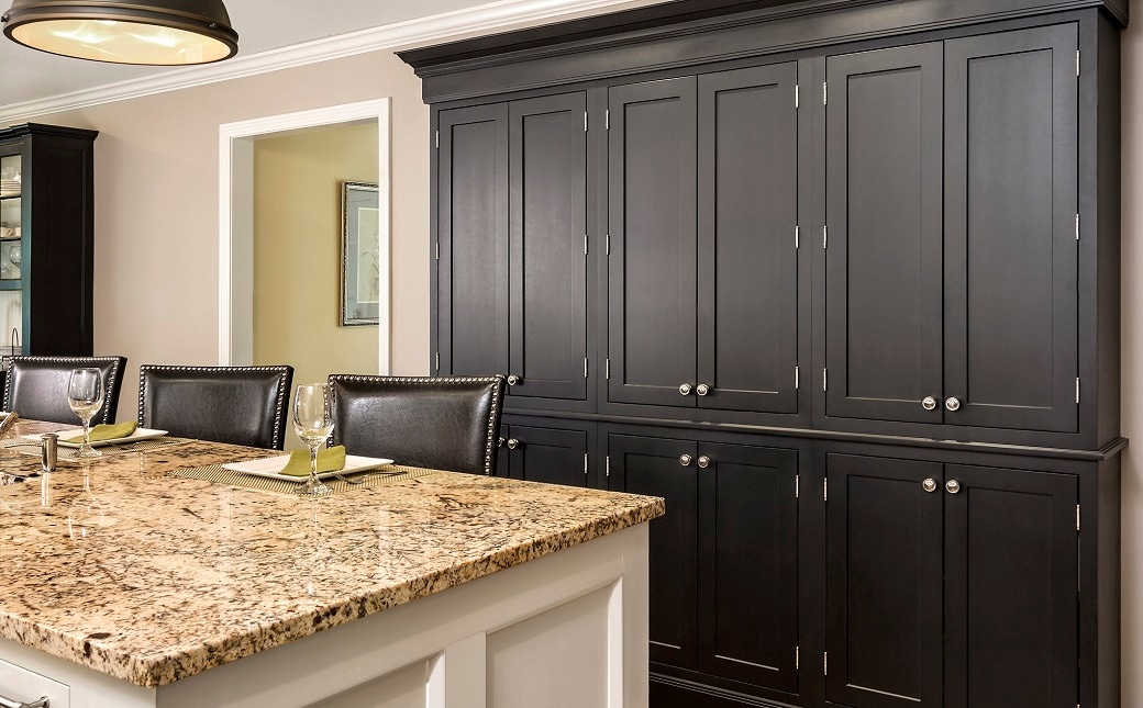 wall of black inset shaker cabinets with exposed nickel-plated hinge barrels and nickel knobs in kitchen with white island cabinets wall of black inset shaker cabinets with exposed nickel-plated hinge barrels and nickel knobs in kitchen with white island cabinets