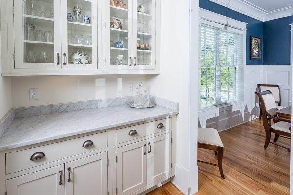 one wall of galley butlers pantry with painted white inset shaker cabinets and glass door storage on wall one wall of galley butlers pantry with painted white inset shaker cabinets and glass door storage on wall
