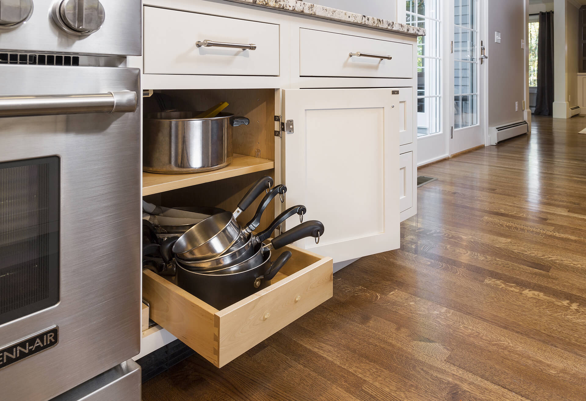 Pull-Out Cabinet Organizers – The Perfect Pots & Pans Storage Solution. This image is of pull-out cabinet organizers – the perfect pots & pans storage solution.