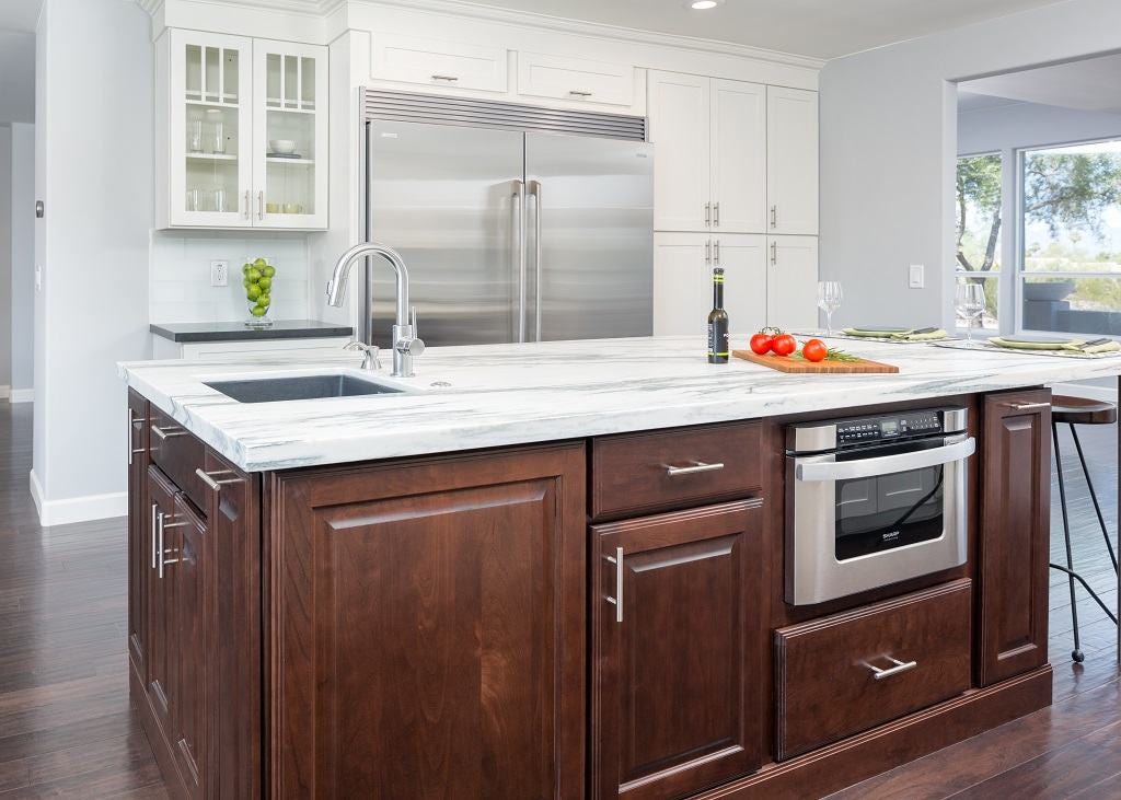 center island built of raised panel cherry cabinets with stainless bar pulls, white marble countertop, prep sink and microwave drawer in kitchen with white shaker perimeter cabinets and hardwood floor center island built of raised panel cherry cabinets with stainless bar pulls, white marble countertop, prep sink and microwave drawer in kitchen with white shaker perimeter cabinets and hardwood floor