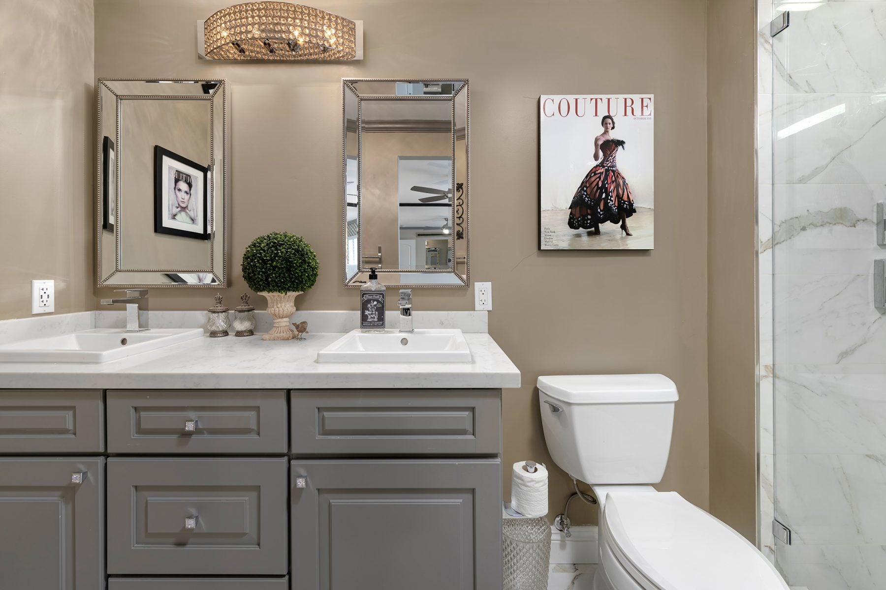 Gray raised panel vanity cabinets Medium-gray raised panel vanity cabinets with two drop-in sinks, white quartz countertops and taupe wall paint