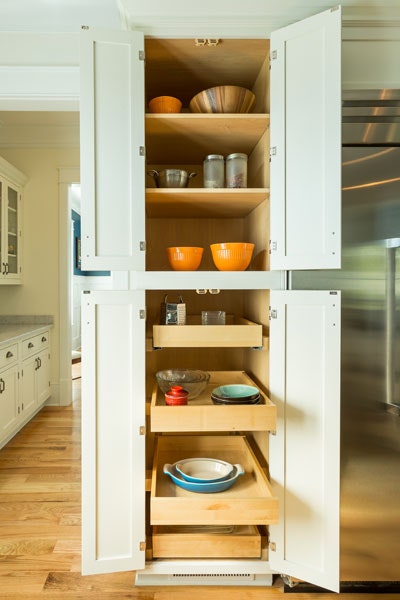 Tall pantry cabinet with upper shelves and bottom roll-out trays, shown in a Shaker style and White paint. Tall pantry cabinet with upper shelves and bottom roll-out trays, shown in a Shaker style and White paint.