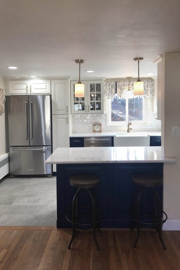 Small blue and white galley kitchen with peninsula cabinets Small blue and white galley kitchen with peninsula cabinets