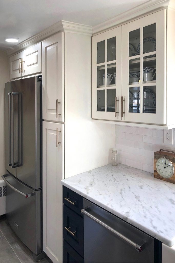 Cabinets around the refrigerator and glass front wall cabinets Cabinets around the refrigerator and glass front wall cabinets