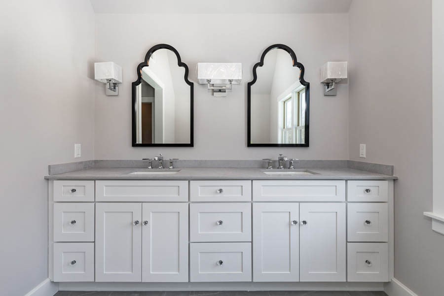White shaker vanity cabinets Gray master bathroom with a double-sink white shaker bathroom cabinet with drawers and decorative black framed mirrors