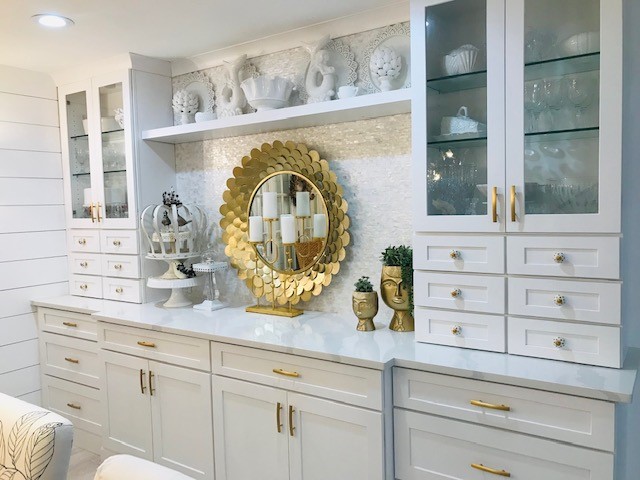 White shaker buffet cabinets with wall towers flanking each end, glass wall cabinets above and mini storage drawers beneath White shaker buffet cabinets with wall towers flanking each end, glass wall cabinets above and mini storage drawers beneath
