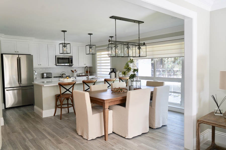 Open white kitchen with countertop seating and formal dining table Open white kitchen with countertop seating and formal dining table
