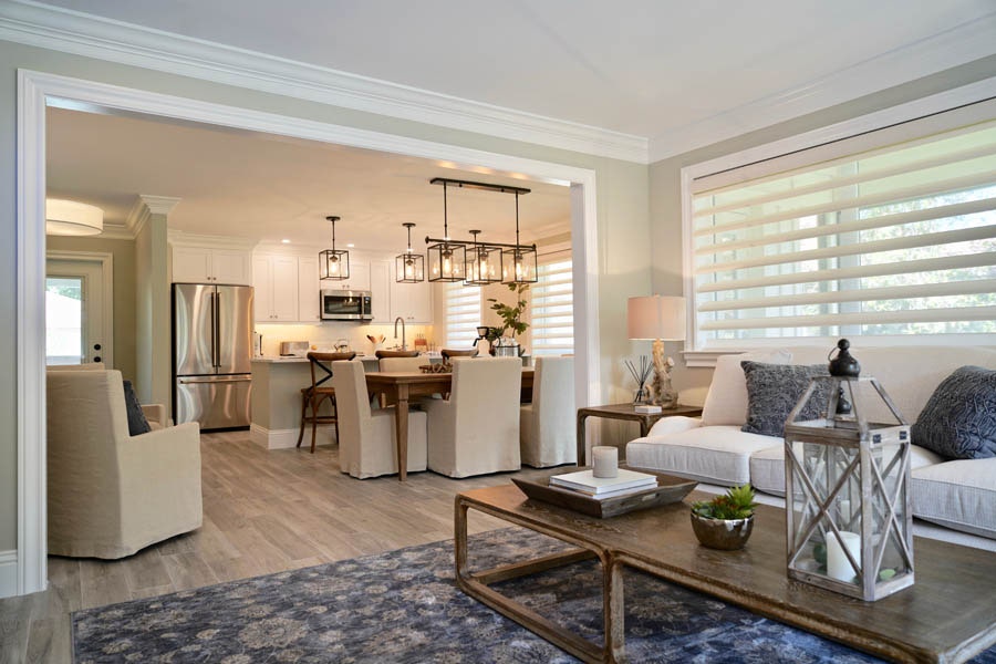 Open floor plan with living room and formal dining area leading to the white kitchen Open floor plan with living room and formal dining area leading to the white kitchen