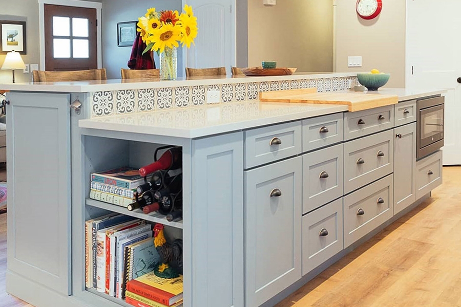 Large Blue-Gray color two-tier island with white countertops and blue tile backsplash and farmhouse hardware cup pulls Large Blue-Gray color two-tier island with white countertops and blue tile backsplash and farmhouse hardware cup pulls