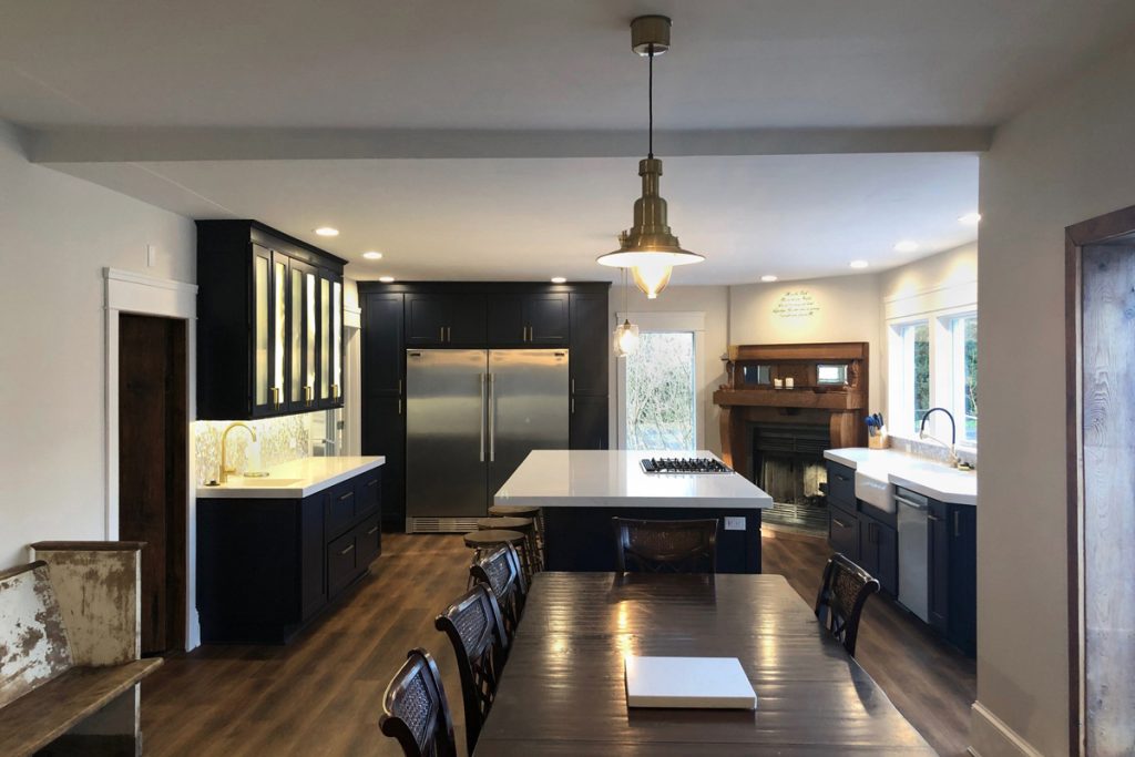 Large blue and white kitchen with wet bar, island, and sink under window Large blue and white kitchen with wet bar, island, and sink under window