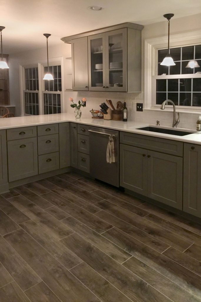 Gray kitchen cabinets and pull-out storage surround the kitchen sink Gray kitchen cabinets and pull-out storage surround the kitchen sink