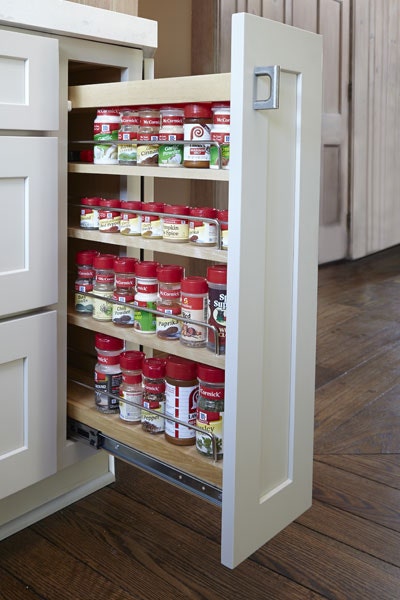 Pull-out storage cabinet with three shelves storing spices Pull-out storage cabinet with three shelves storing spices