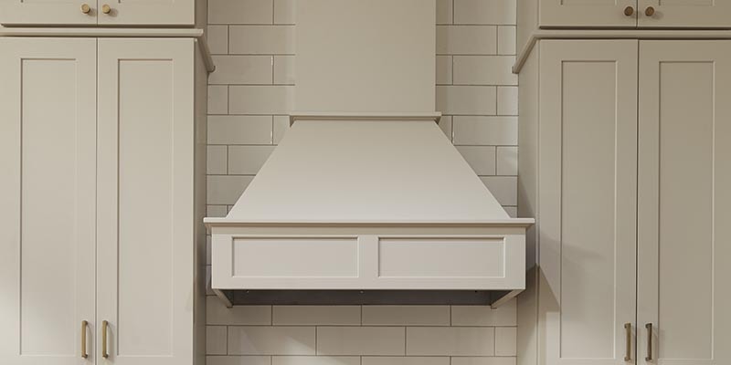 CliqStudios Shaker wall cabinets in Painted light gray with a chimneyed wood range hood in the shaker straight style CliqStudios Shaker wall cabinets in Painted light gray with a chimneyed wood range hood in the shaker straight style
