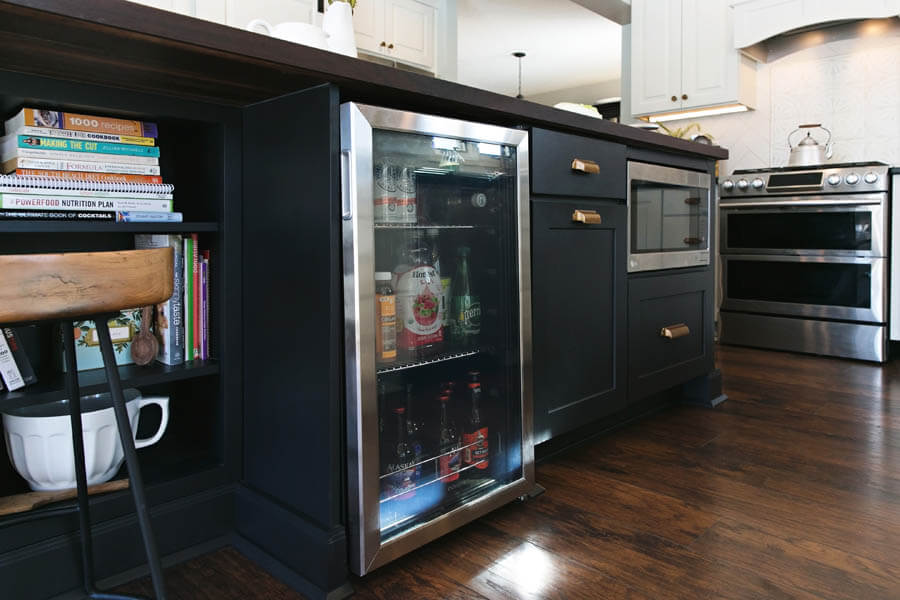 Beautiful Bar Cabinets. This image is of bar cabinets with fridge. Beverage coolers are built directly into a run of cabinets allowing easy access to all your favorite cocktail mixers, local brews, and non-alcoholic beverages while keeping them chilled.