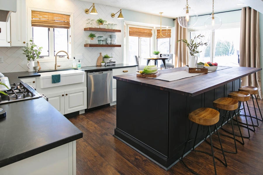 eclectic kitchen with black kitchen island, wood bar stools, and white cabinet perimeter eclectic kitchen with black kitchen island, wood bar stools, and white cabinet perimeter
