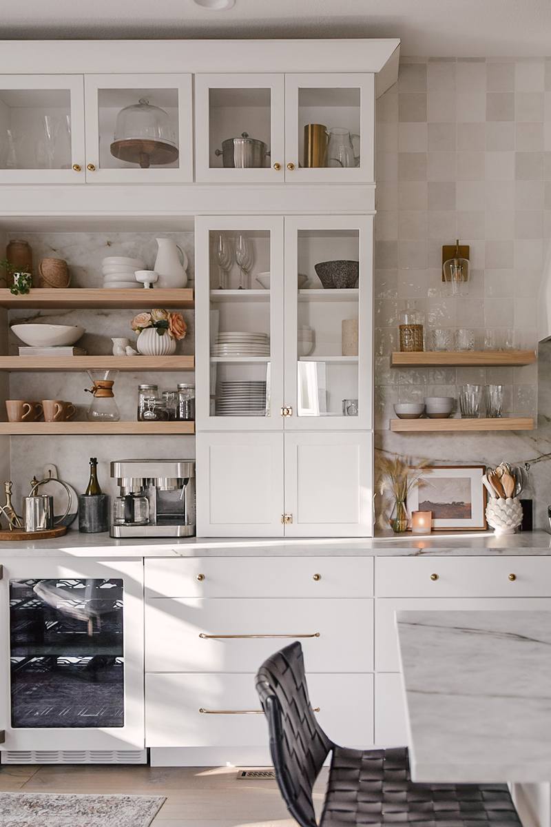 CliqStudios project: Painted white shaker buffet kitchen cabinet towers with natural wood floating shelves in between and three drawer base kitchen cabinets below CliqStudios project: Painted white shaker buffet kitchen cabinet towers with natural wood floating shelves in between and three drawer base kitchen cabinets below