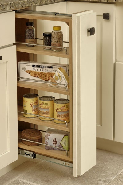 Base pull-out storage cabinet with three shelves storing cans, crackers, tea, and herbs Base pull-out storage cabinet with three shelves storing cans, crackers, tea, and herbs