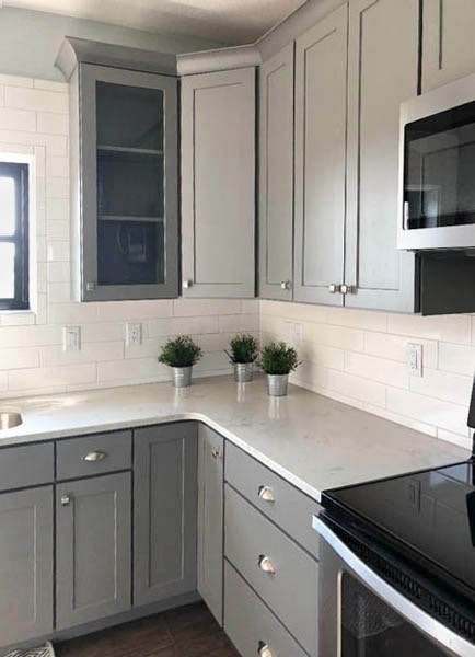 Glass kitchen cabinet doors in medium gray surround kitchen sink Glass kitchen cabinet doors in medium gray surround kitchen sink