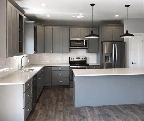 Open kitchen with island, gray cabinets, white countertops and subway tile backsplash Open kitchen with island, gray cabinets, white countertops and subway tile backsplash