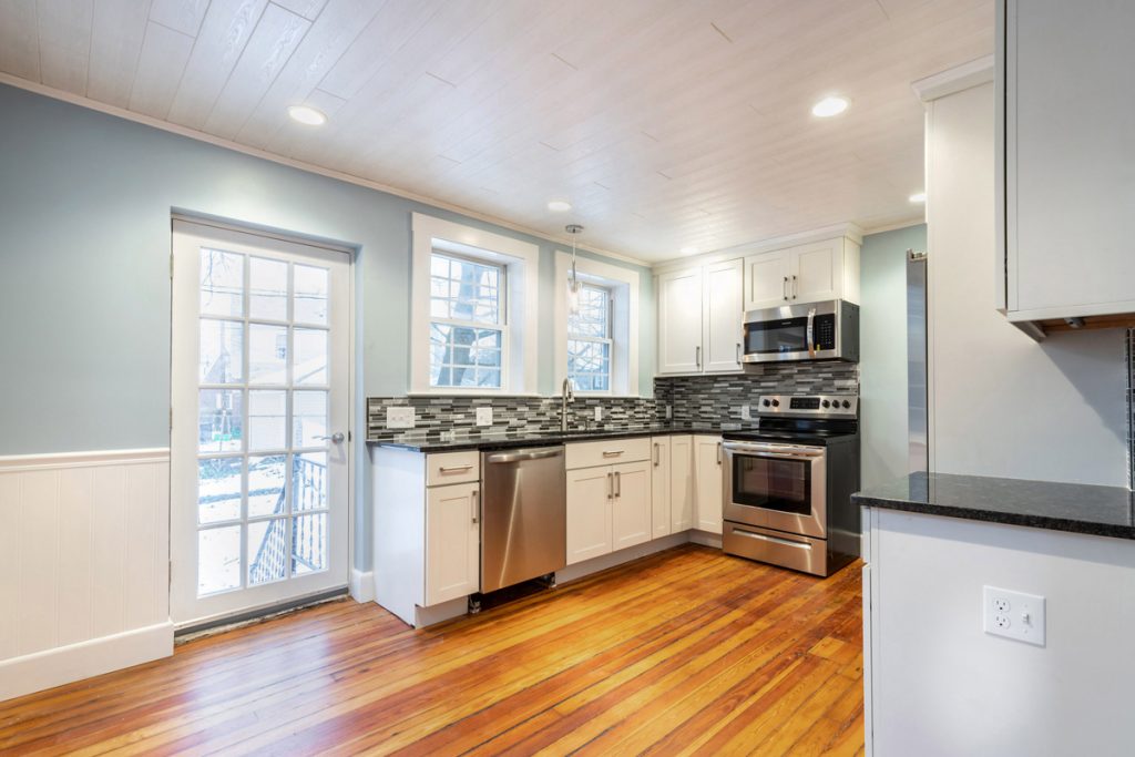 updated kitchen with white cabinets and stainless appliance, with original hardwood floors updated kitchen with white cabinets and stainless appliance, with original hardwood floors
