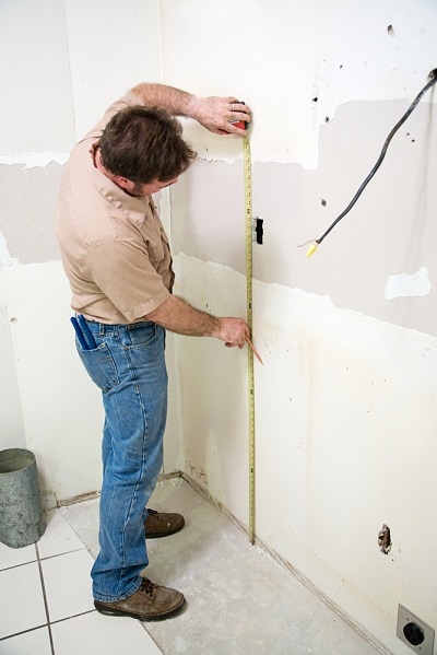 contractor measuring wallboard in kitchen remodel contractor measuring wallboard in kitchen remodel