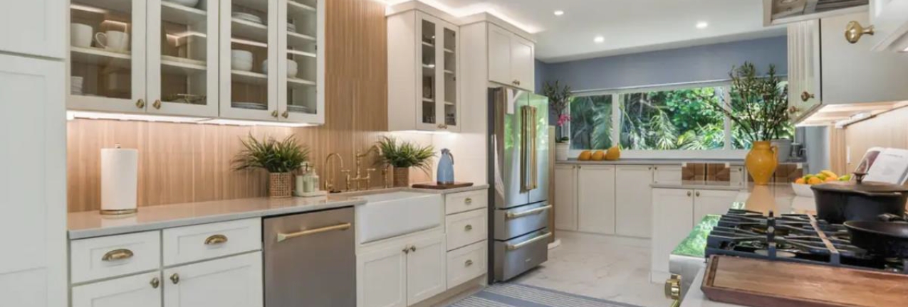 Harrison Divinity kitchen cabinets Galley-style white shaker kitchen design with wood slat backsplash and white stone countertops