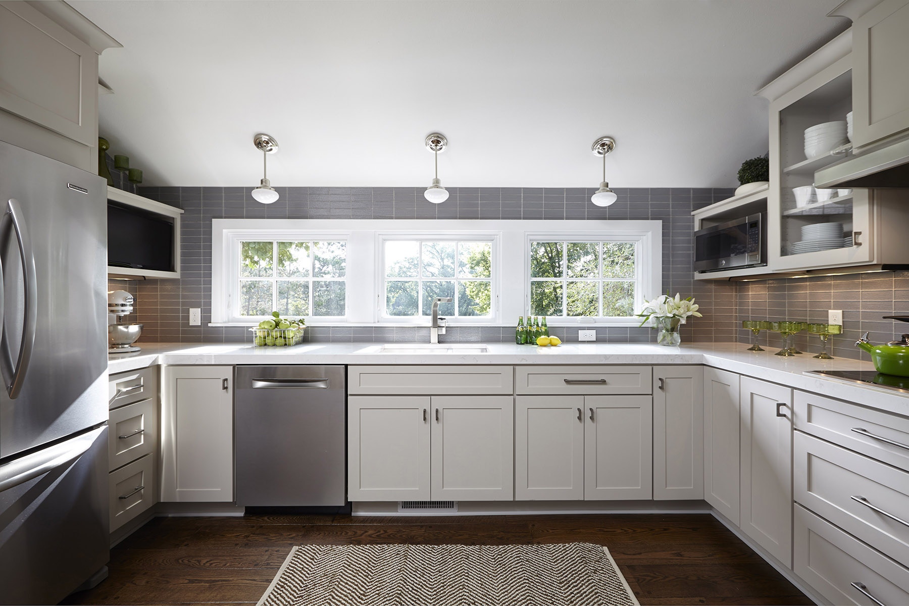 Gray kitchen with shaker cabinets and large bank of windows Gray kitchen with shaker cabinets and large bank of windows