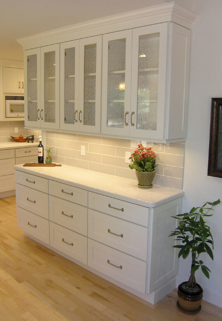 White Bar Cabinets This image is of a white bar cabinet in a house. If you are drawn to a fresh, light, and airy design, then white bar cabinets will be an excellent addition to your home.