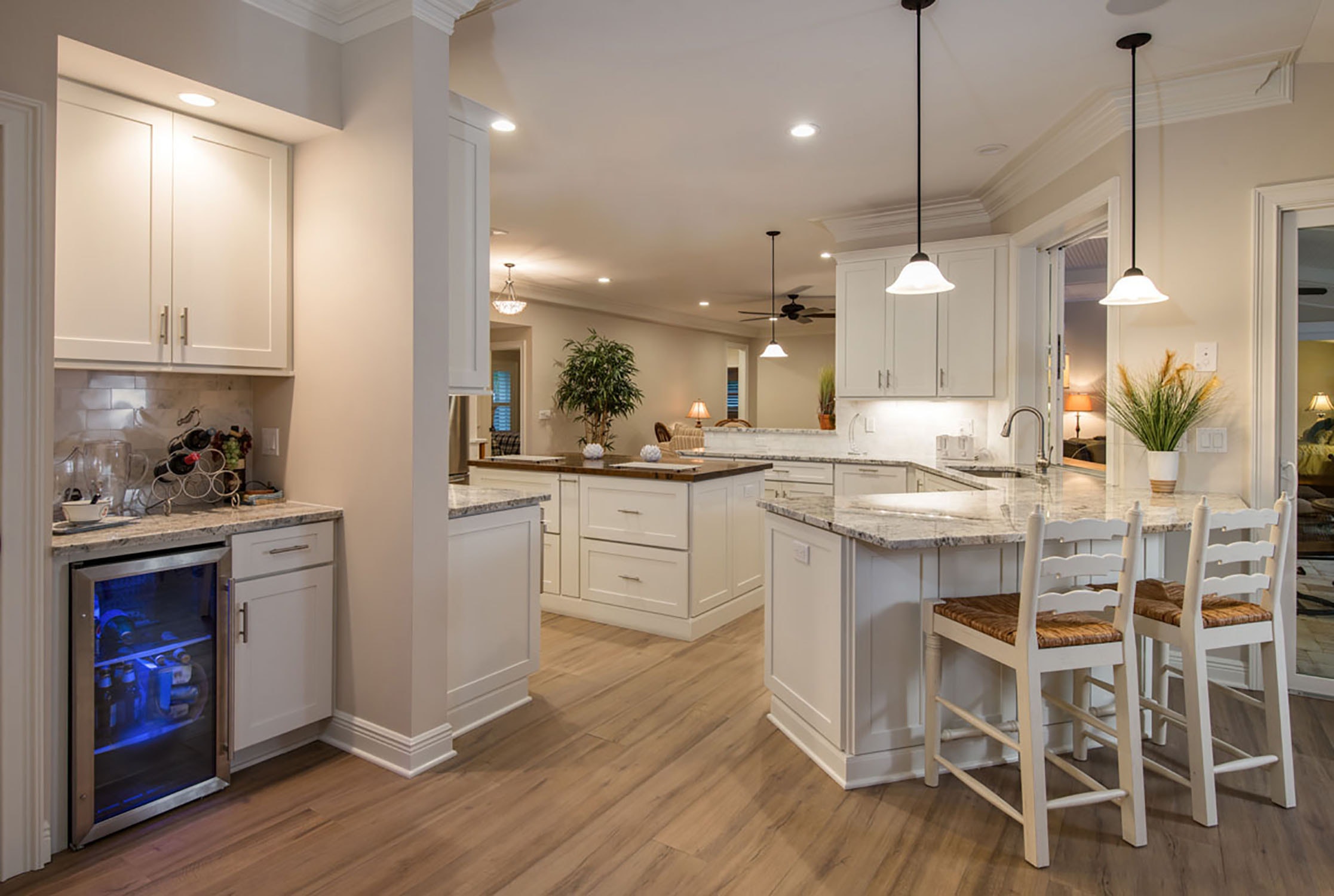 large open kitchen with peninsula, island, bar and look-through wall to living area large open kitchen with peninsula, island, bar and look-through wall to living area