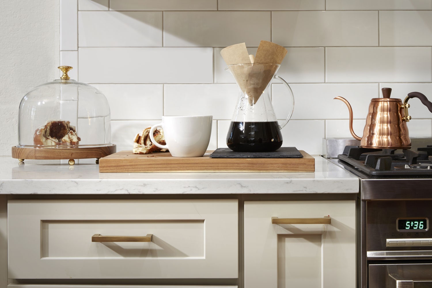 shaker white kitchen cabinets with pastries and pour over coffee brewing on countertop shaker white kitchen cabinets with pastries and pour over coffee brewing on countertop