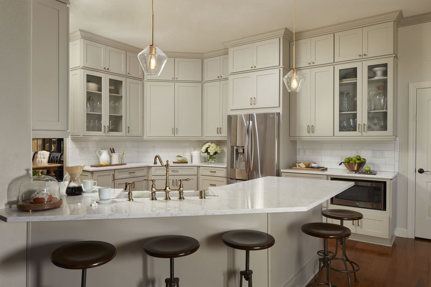 Transitional gray kitchen remodeled with white countertops and glass cabinet doors Transitional gray kitchen remodeled with white countertops and glass cabinet doors