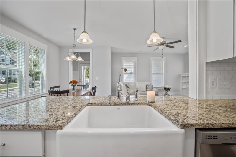 How To Know Which Countertop Is Right for You White kitchen design with granite countertops and a white cast iron farm sink