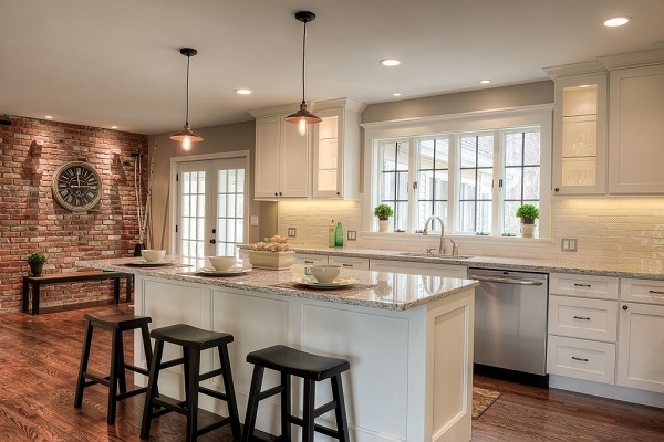 shaker white cabinets in small open kitchen with wide-plank oak floors, brick wall and mullion windows and glass cabinets lit from inside shaker white cabinets in small open kitchen with wide-plank oak floors, brick wall and mullion windows and glass cabinets lit from inside