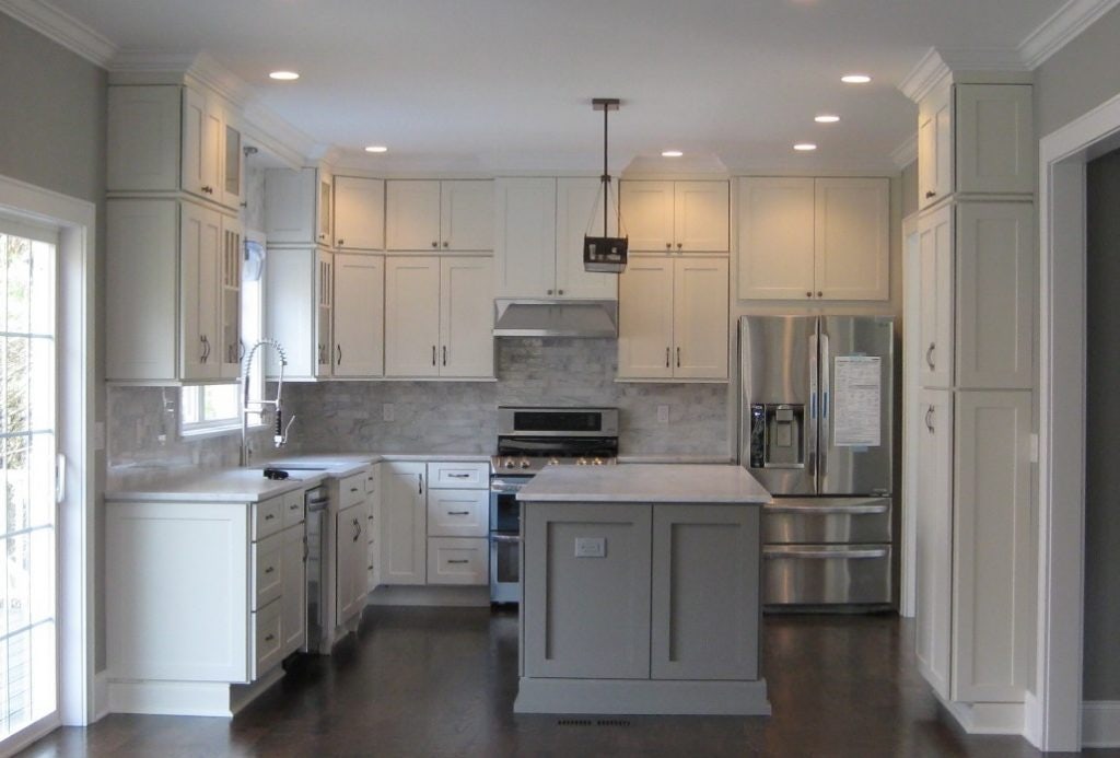kitchen has white shaker cabinets on the perimeter, gray marble backsplash, soft gray island cabinets and a dark hardwood floor kitchen has white shaker cabinets on the perimeter, gray marble backsplash, soft gray island cabinets and a dark hardwood floor