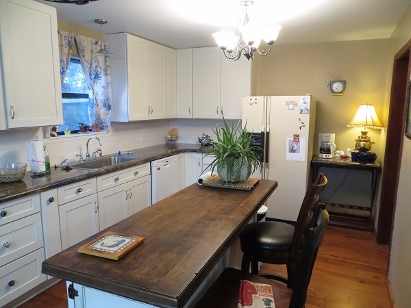 Tennessee kitchen has white shaker cabinets and unique vintage island with solid wood slab counter Tennessee kitchen has white shaker cabinets and unique vintage island with solid wood slab counter