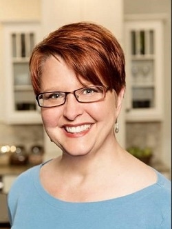 portrait of kitchen designer Rachel Brune, a young woman with short red hair and glasses portrait of kitchen designer Rachel Brune, a young woman with short red hair and glasses
