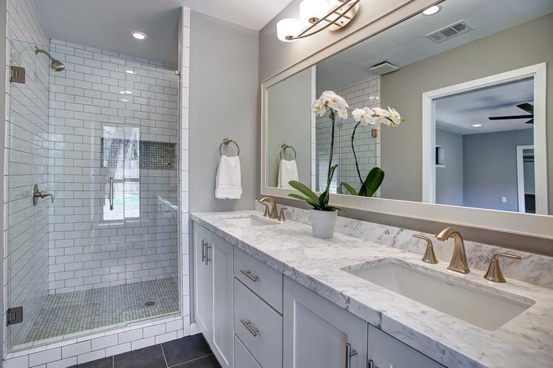 White shaker vanity cabinets Master bathroom with white shaker vanity cabinets, double sinks and a walk-in tile shower
