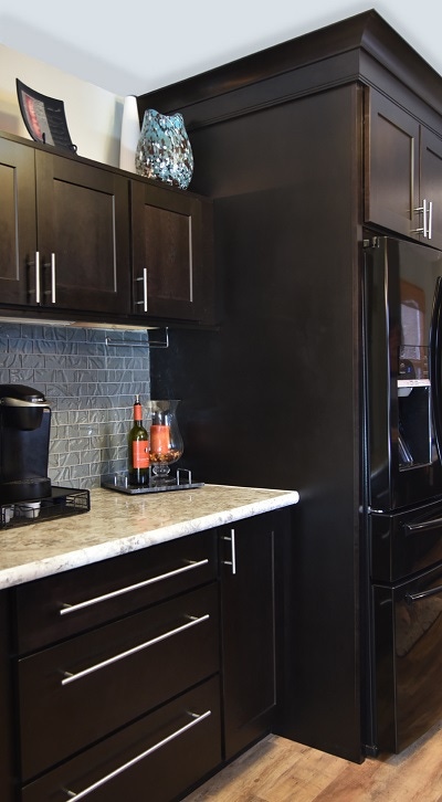 Custom beverage station built of black stained birch shaker cabinets has extra height above the counter to allow access to the coffee maker, and above-cabinet display space for glass art Custom beverage station built of black stained birch shaker cabinets has extra height above the counter to allow access to the coffee maker, and above-cabinet display space for glass art