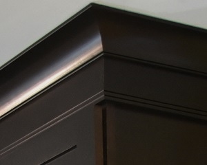 close up view of espresso birch cabinets shows stacked crown molding, simply styled with cove and ogee close up view of espresso birch cabinets shows stacked crown molding, simply styled with cove and ogee